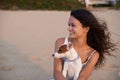 They both love the beach. an attractive young woman enjoying the beach with her dog. Royalty Free Stock Photo