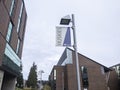 Bothell, WA USA - circa April 2021: Low angle view of a University of Washington Bothell banner on a pole on the campus grounds