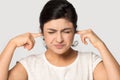 Bothered Indian woman stressed by loud sound Royalty Free Stock Photo