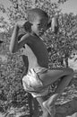 Botswana: a young bushmen kid dancing in the central Kalahari