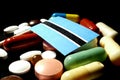 Botswanan flag with lot of medical pills isolated on black background