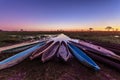Botswanian local mokoro boats in the sunset time, on the shore of delta Okavango river, Botswana Royalty Free Stock Photo