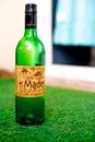 Bottle of alcohol liquor wine beer placed on grass in home garden showing home picnic with home delivered alcohol in