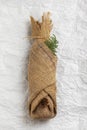Bottle of alcohol or wine wrapped in sackcloth fabric. Royalty Free Stock Photo