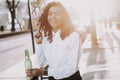 Bottle of Alcoholic Beverage. Girl. Curly. Stand. Royalty Free Stock Photo