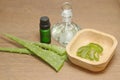 Bottle of aloe vera essential oil with fresh plant