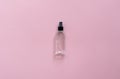 Bottle of antiseptic, a bottle of hand sanitizer, hand sanitizer spray on a pink background, for the prevention of