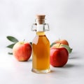 Bottle apple cider vinegar and fresh apples in white backgrounds Royalty Free Stock Photo