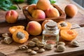 A bottle of apricot kernel oil with apricot kernels and apricots Royalty Free Stock Photo