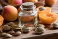 A bottle of apricot kernel oil with fresh apricots