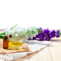 Bottle of aroma essential oil or spa and natural fragrance oil with flower on wooden table