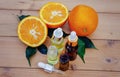 bottle of aromatic essence and fresh orange on the background of nature. Royalty Free Stock Photo