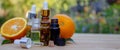 bottle of aromatic essence and fresh orange on the background of nature. Royalty Free Stock Photo