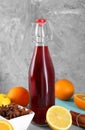 Bottle of aromatic punch drink and ingredients on light blue table Royalty Free Stock Photo