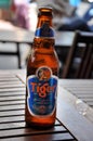 Bottle of Asian lager Tiger beer on a wooden table in a Vietnamese restaurant