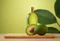 Bottle of avocado essential oil with golden lid and fresh avocado fruit and leaves in the background