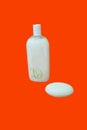 Bottle of beauty body care bathroom toiletry and a soap tablet. Royalty Free Stock Photo