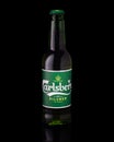 Bottle of beer Carlsberg on black background, studio shooting, vertical Royalty Free Stock Photo
