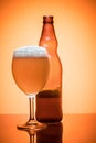 Bottle of beer and glass full foam condensate cold refreshing Royalty Free Stock Photo