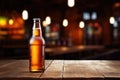 Bottle of beer and glass of beer on a wooden table against the background of a pub Royalty Free Stock Photo