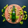 A bottle of beer, hops and grain. Top view. Royalty Free Stock Photo
