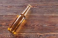 Bottle of beer lying on wooden table. Royalty Free Stock Photo