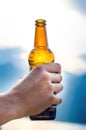 Bottle of beer. Natural background. Man handÃÂ´s keep a bottle of beer. Alcohol drink. Royalty Free Stock Photo