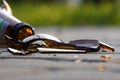 Bottle of beer, soda or drugs from dark glass is broken. Shattered beer bottle on ground in sunset light. Fragments of glass on Royalty Free Stock Photo