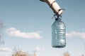 a bottle of birch sap hanging on a tree in early spring while collecting nectar against a blue sky Royalty Free Stock Photo
