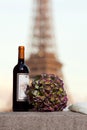 Bottle and a bouquet of flowers near the Eiffel Tower