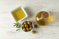 Bottle and bowl with olive oil, bowl with olives on background, top view Royalty Free Stock Photo