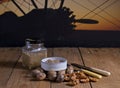 Bottle and bowl of pecan nut butter with silhouette of airplane in background