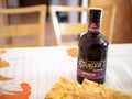 Bottle of Bozkov Republica Espresso rum alcohol on a table with a cake Royalty Free Stock Photo