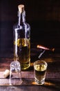 Bottle of brazilian traditional cachaÃÂ§a. Used to make caipirinha drink. Alcohol distilled drink on barrel bottom, personal Royalty Free Stock Photo