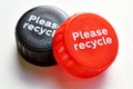 Bottle caps with please recycle message Royalty Free Stock Photo
