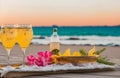 bottle of champagne on a beach with two glasses full on a romantic evening on beach Royalty Free Stock Photo