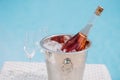 bottle of champagne in bucket with ice and two empty glasses Royalty Free Stock Photo