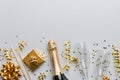 Bottle of champagne with colored glitter, confetti and gift box space for text on colorfull background, top view Royalty Free Stock Photo