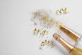 Bottle of champagne, glass with gold glitter and space for text on white background. Hilarious celebration Royalty Free Stock Photo