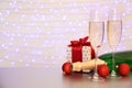 Bottle of champagne, glasses and Christmas gift Royalty Free Stock Photo