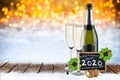 Bottle of champagne with glasses cork and blackboard german greeting frohes neues jahr 2020 greetings english translation: happy Royalty Free Stock Photo