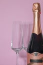 Bottle of champagne with glasses on a pink background Royalty Free Stock Photo