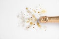 Bottle of champagne with gold glitter and confetti on white background, top view. Royalty Free Stock Photo