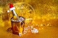 A bottle of champagne in a golden bucket with ice and two glasses Royalty Free Stock Photo