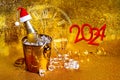 A bottle of champagne in a golden bucket with ice and two glasses Royalty Free Stock Photo