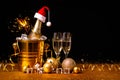 A bottle of champagne in a golden bucket with ice and two glasses Royalty Free Stock Photo