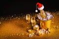 A bottle of champagne in a golden bucket with ice and two glasses Royalty Free Stock Photo