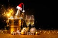 A bottle of champagne in a golden bucket with ice and two glasses of champagne Royalty Free Stock Photo