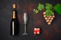 Bottle of champagne, grape bunch of cork with leaves, wineglass