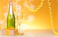 A bottle of champagne, a New Year`s gift on a yellow shimmering